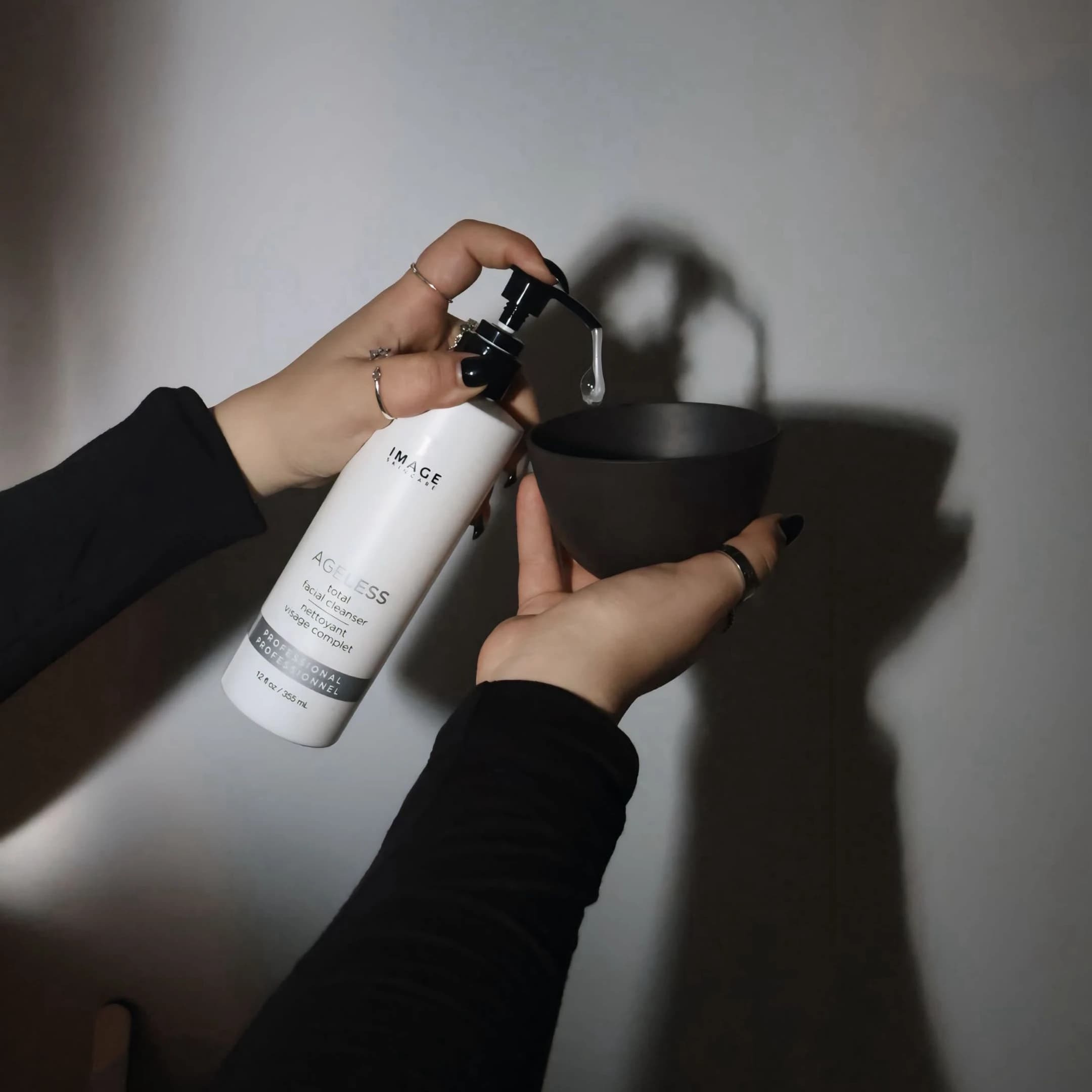 Pouring cleanser during a facial at MJM Aesthetics